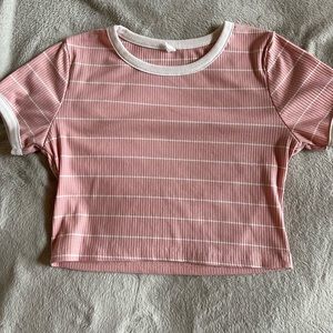 From Skein. Baby pink crop top with white strips